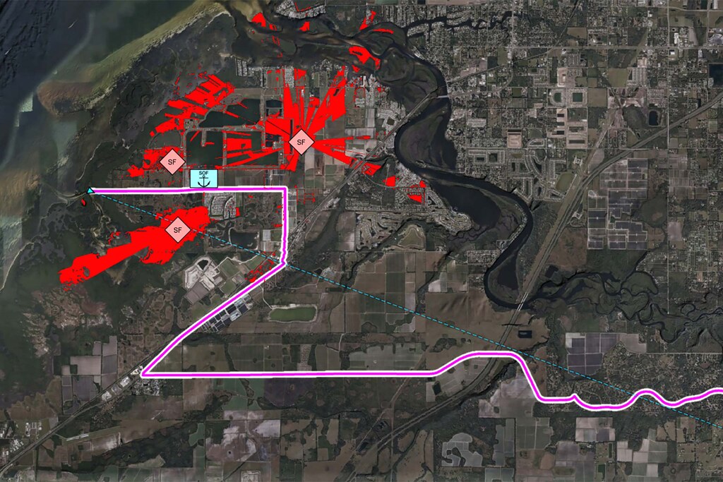 The image shows a map of a coastal area. Enemy line of sight is highlighted in red. A UGV route is shown in pink, finding a path that stays out of enemy line of sight. 