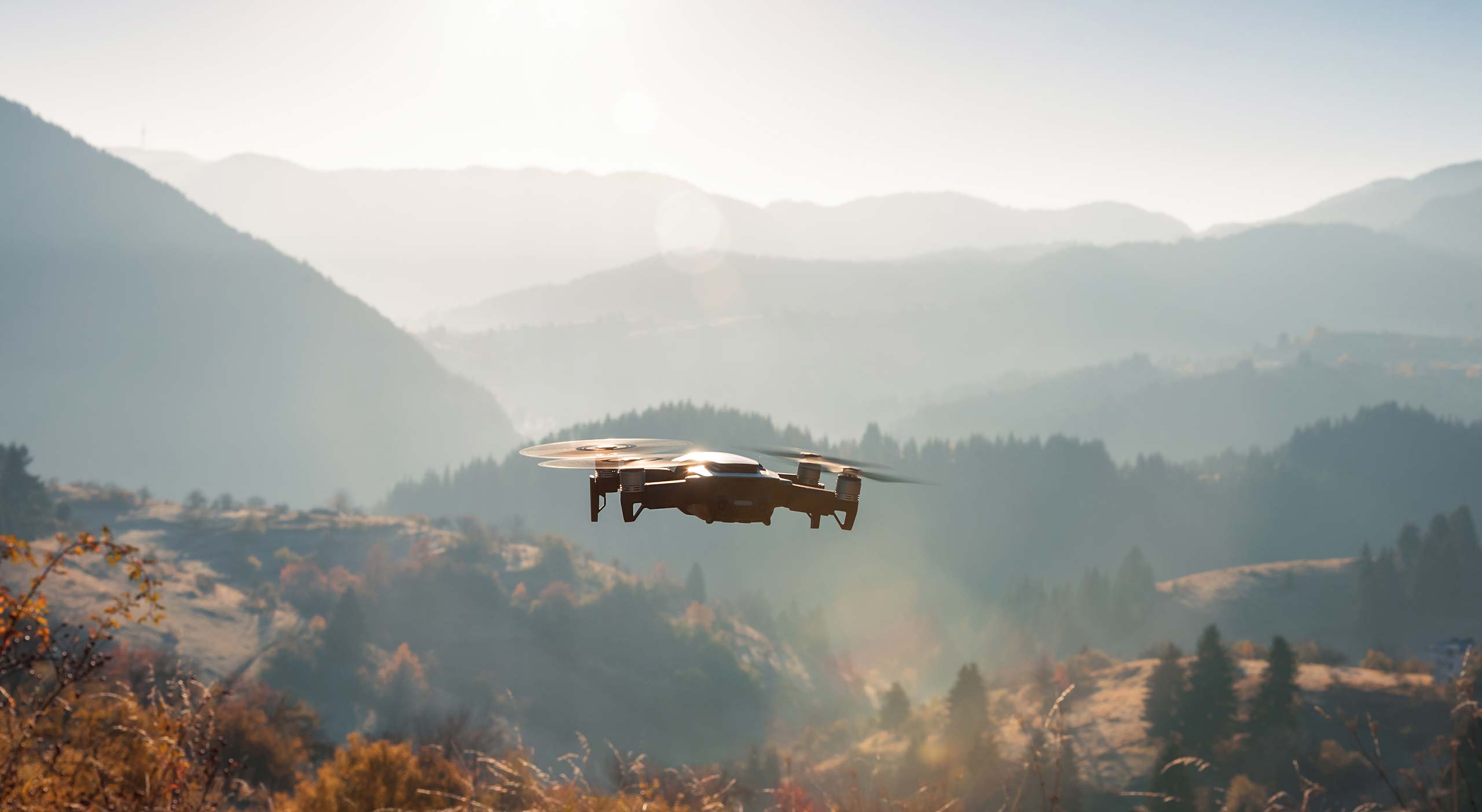 Drone flying above mountains.